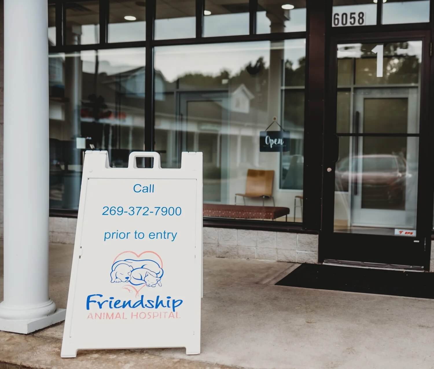 Exterior entrance of a veterinary clinic with a Friendship Animal Hospital sign out front in Kalamazoo